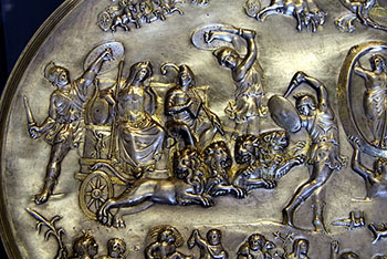 Image showing a crowned Cybele in a cart being pulled by lions through the heavens surrounded by other deities.