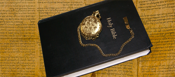 Picture of the Bible and a pocket watch.